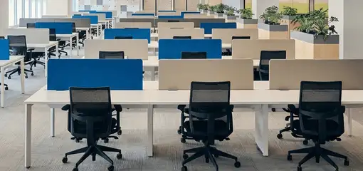 Modern open-plan office space featuring clean workstations, ergonomic chairs, and sanitized carpets provided by professional office cleaning services in Cleveland, OH.