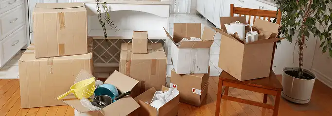 Packed moving boxes and household items in a kitchen before move-out or move-in cleaning, Cleveland, OH.
